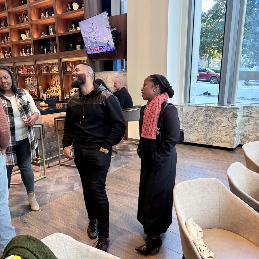 Brand Mates talking in a hotel lobby